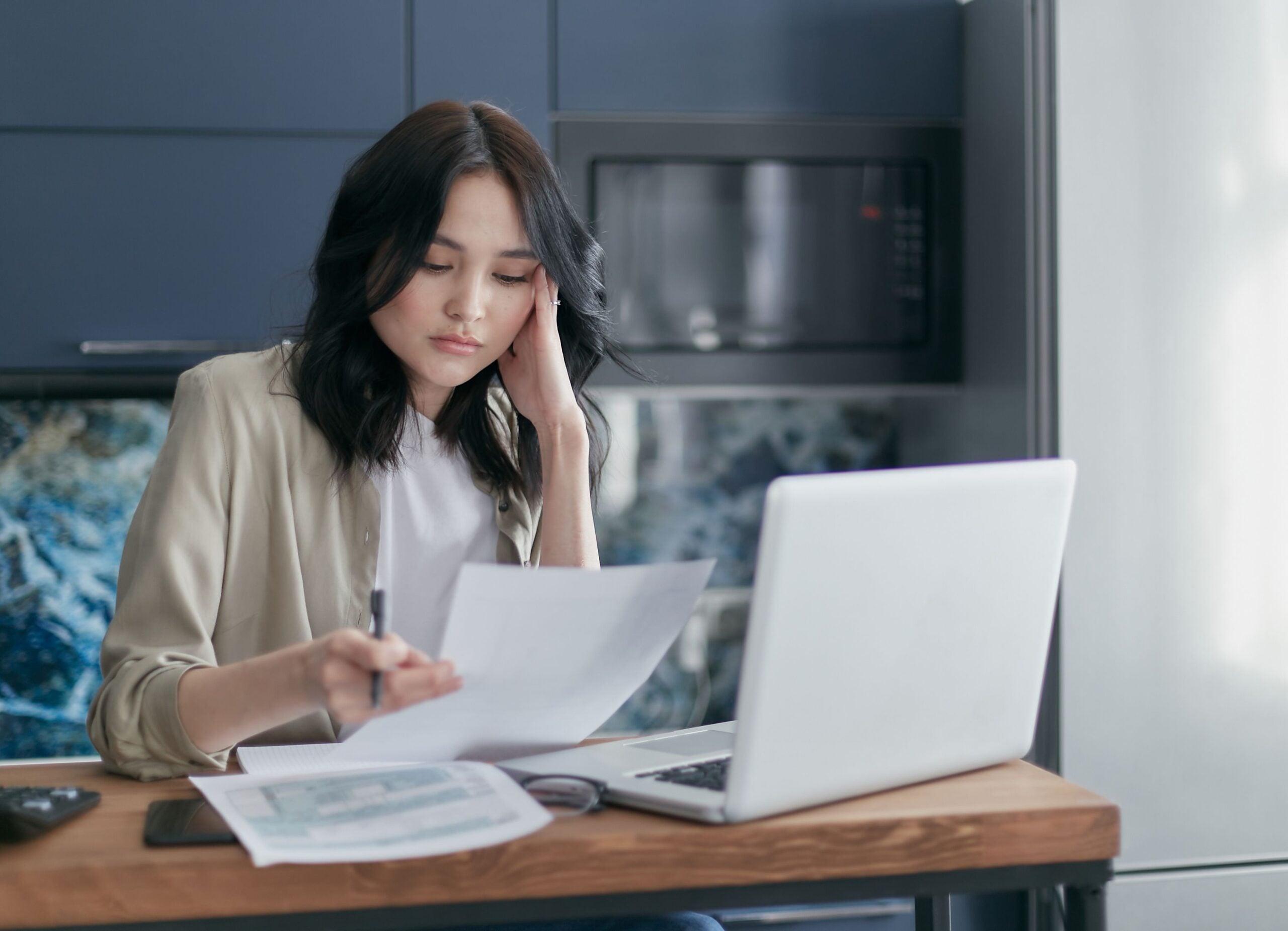 Person reviewing financial planning documents on a laptop